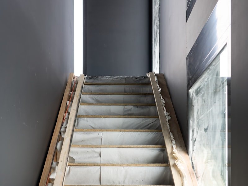 A staircase mid-renovation being recapped with new treads