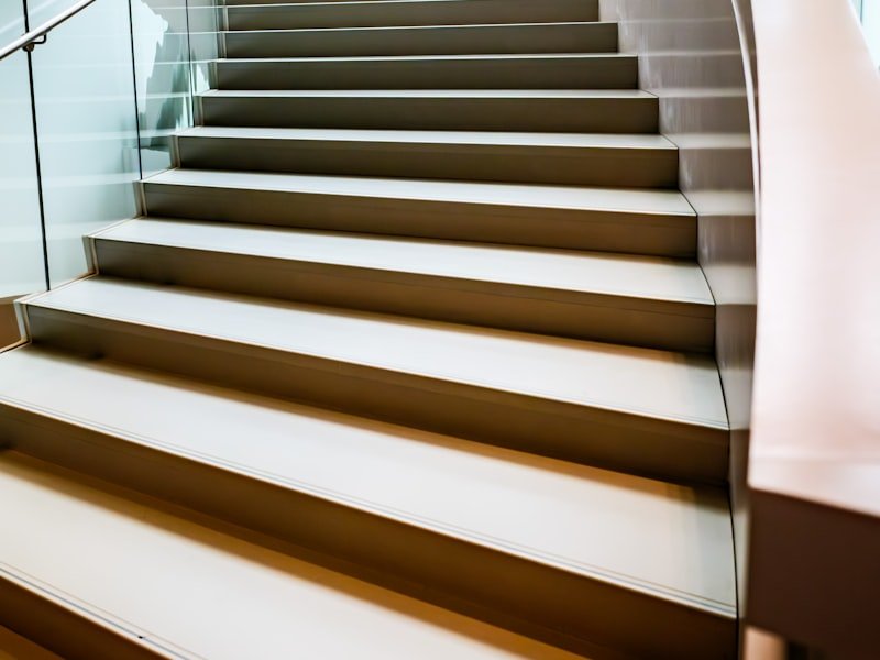 Curved staircase with a modern glass railing