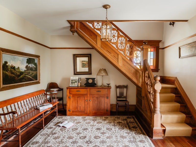 A heritage carved-wood staircase being preserved and refinished