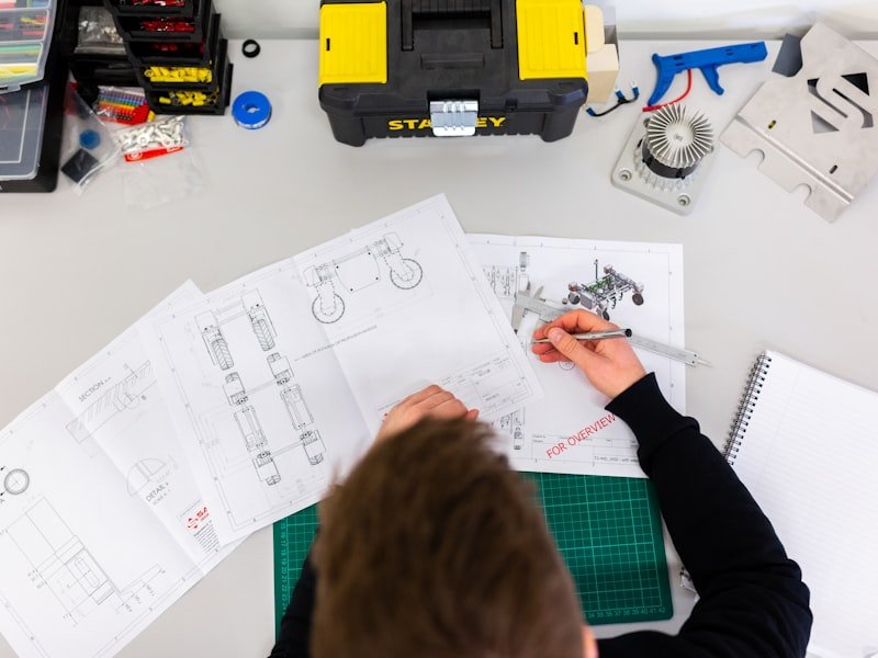 A designer reviewing CAD drawings and measurements for a staircase